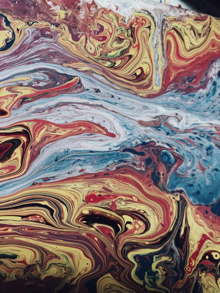 pexels-photo-3848557-3848557 Dynamic abstract art with swirling colorful paint patterns, showcasing a vivid blend of hues.